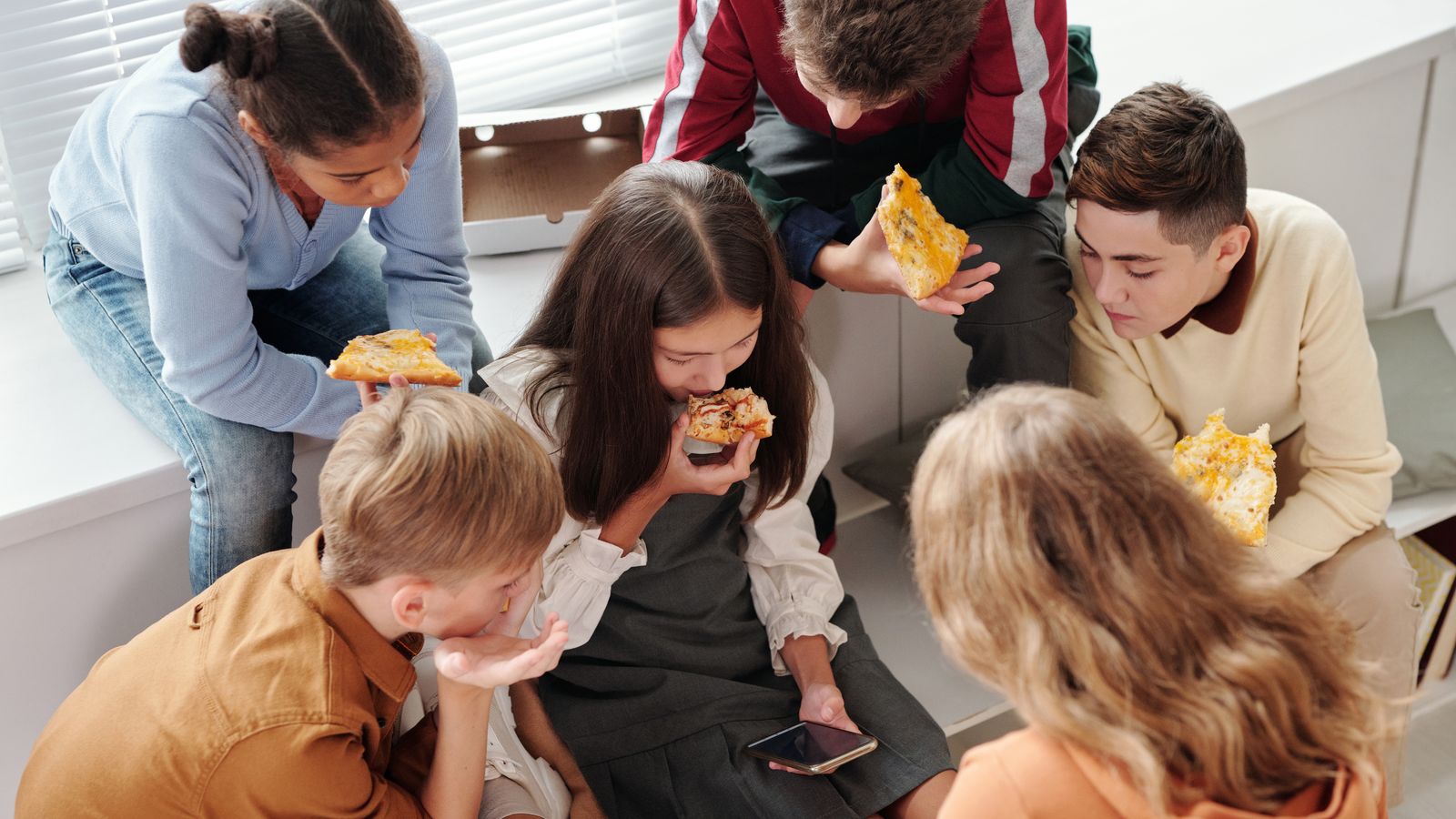 Children enjoying pizza
